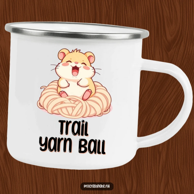 Funny giggling hamster character rolling happily in a pile of soft yarn, a sturdy enamel mug for outdoor relaxation.