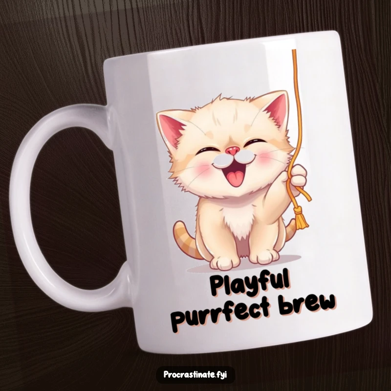 Funny giggling kitten playfully batting at a dangling string of yarn, depicted on a humorous mug.