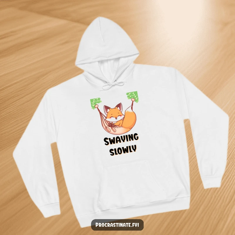 Funny relaxed fox sprawled on a hammock, gently swaying, featured on a warm and cozy hoodie.