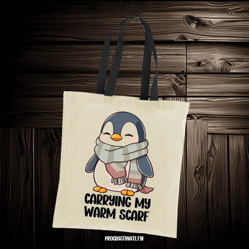 Funny penguin tote bag showing a cozy penguin wrapped in a warm scarf, perfect for carrying items with wintery smiles.